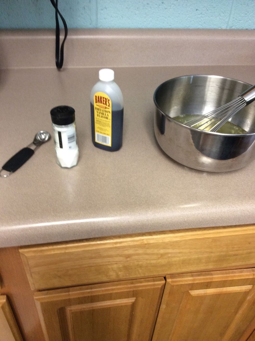 In the egg whites add the cream of tartar, your chosen extract, and the warm water.