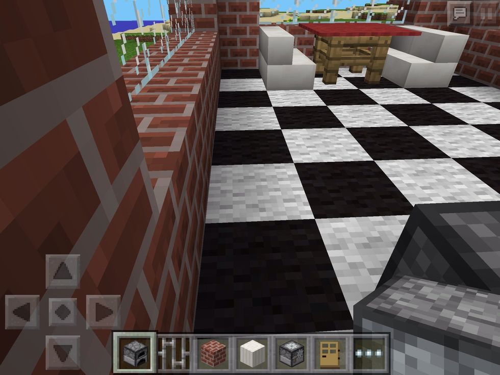 In the gap between the wall and the furnace, stand facing the rest of the room.