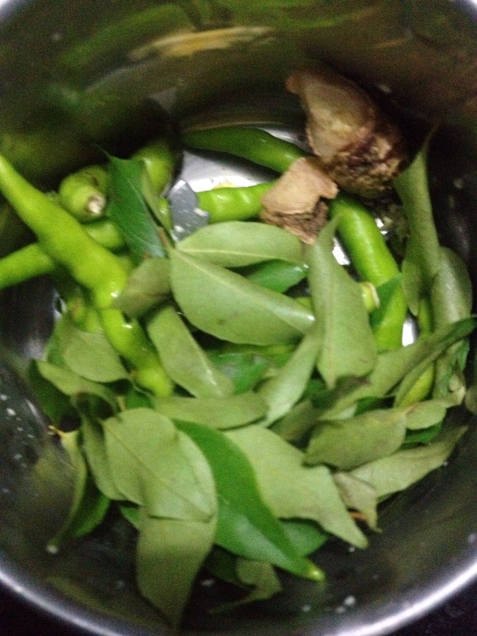 In the grinder add chilli , ginger and curry leaves