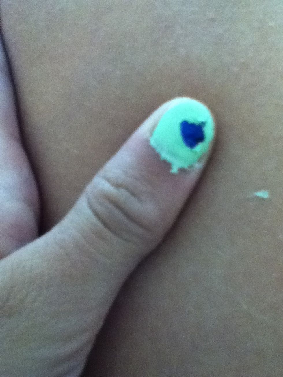 In the hole add the dark blue nail polish.