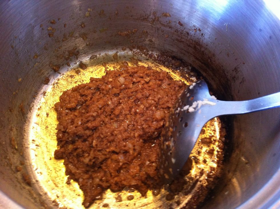 In the left over chicken oil, fry the prawn paste, turmeric and the garlic and onion until very soft. Warning! The prawn paste is very smelly but don't worry - it will taste yum!