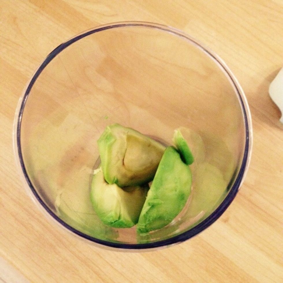 In the meantime peel and remove the pit from the avocados. Place them in a blender cup.