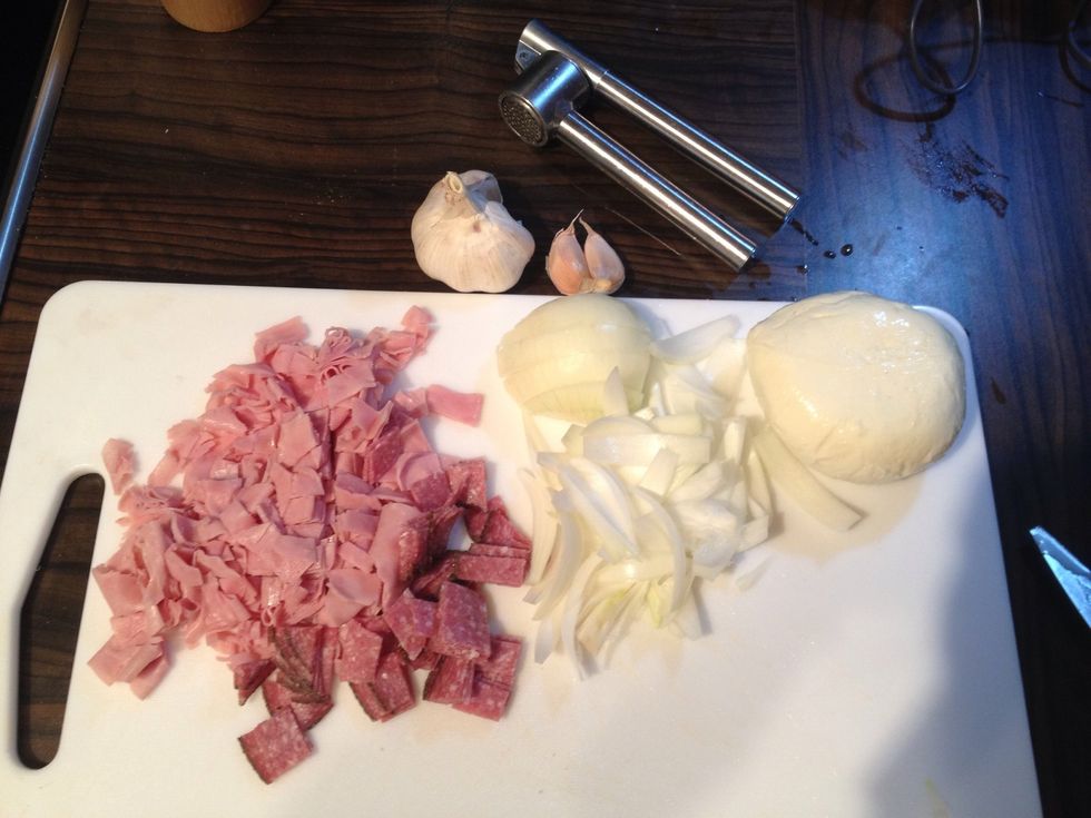 In the meantime prepare your chosen toppings (ham, salami, onion wedges, garlic)