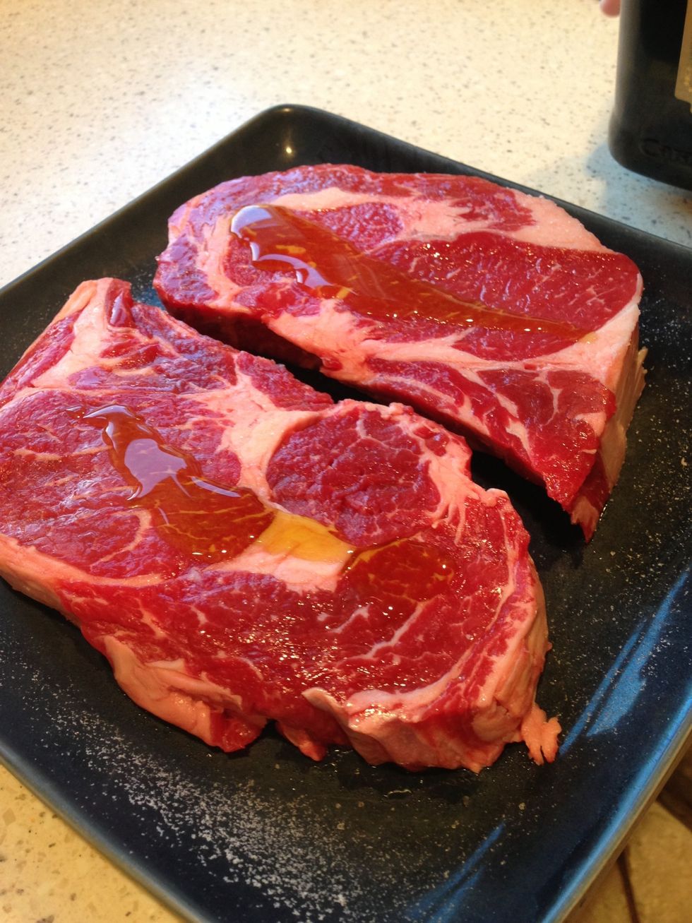In the meantime, put a small amount of the oil onto one side of the steak