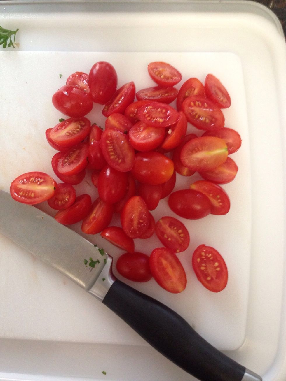 In the meantime, slice all the grape tomatoes in half.