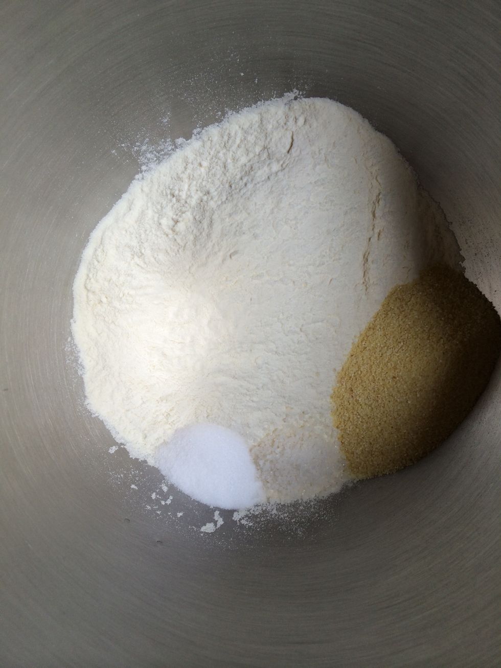 In the mixing bowl of a free standing mixer. (You can always do the dough by hand) put the flour, the semolina, the salt and the baking soda
