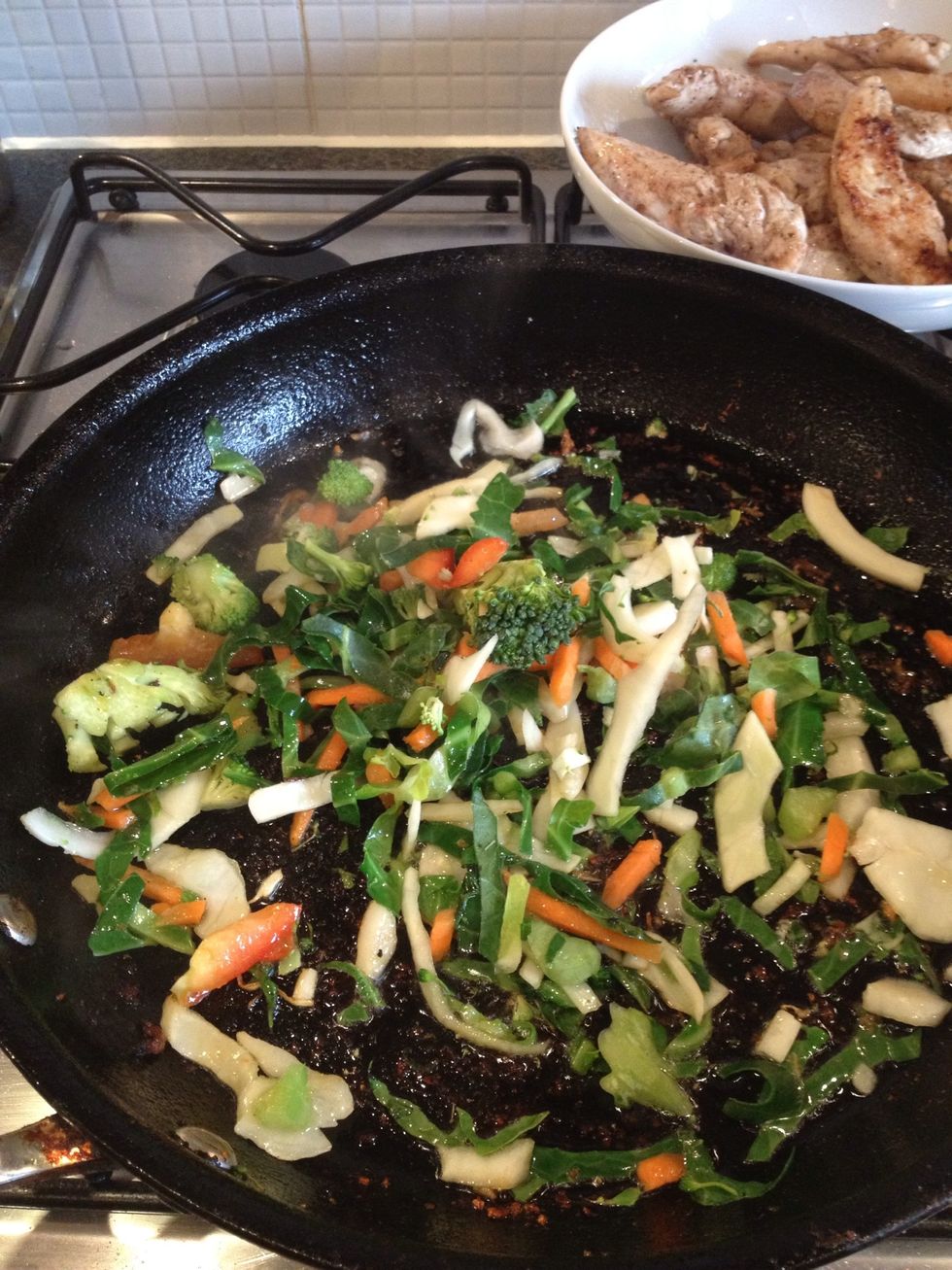 In the remaining oil add around half a bag of Chinese stir fry vegetables and cook in a medium heat for around 3 to 4 minutes. Bags of stir fry vegetables are available from most supermarkets.