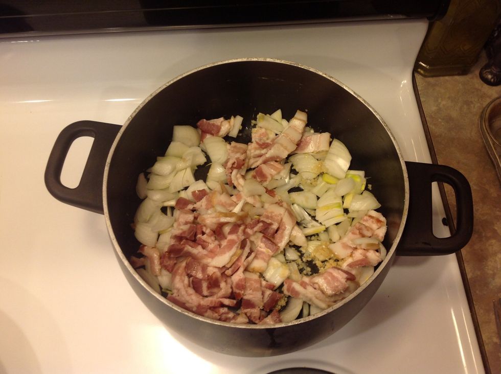 In the same pan, saut\u00e9 bacon, onions and garlic over low-medium heat for approximately 15 mins. or until the onions are soft.