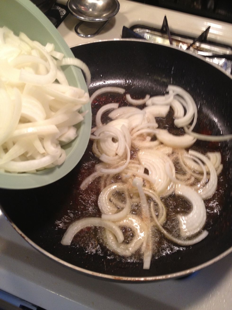 In the same pan we cooked the sausages , we will add the sliced onions. Make sure the heat is still on medium high heat.