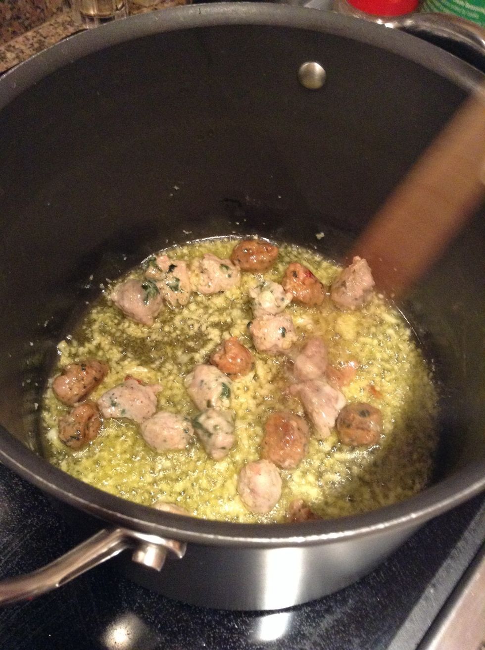 In the same pot add the sausages, minced garlic, and evoo. Cook till sausages are done.