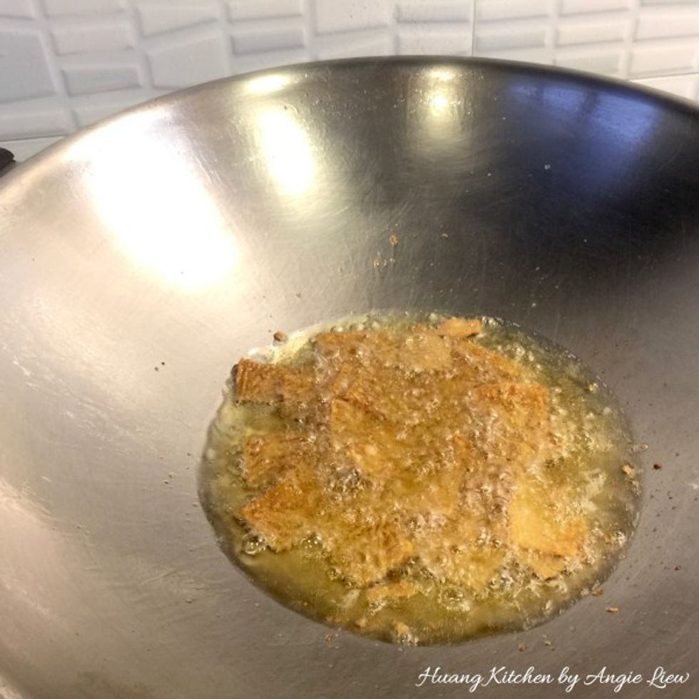 In the same wok, fry the drained and slightly softened sweet beancurd sheets, till golden brown in colour.