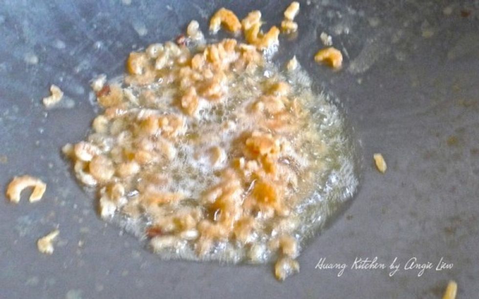 In the same wok, fry the dried shrimp till fragrant and golden brown in colour.