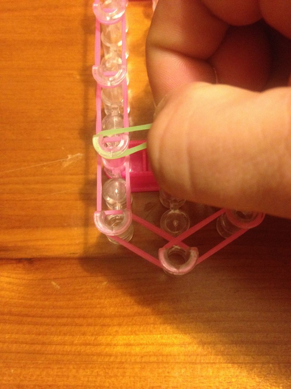 In the second left hand pin loop the "b" green band on it pull to the right hand side but twist it as you do.