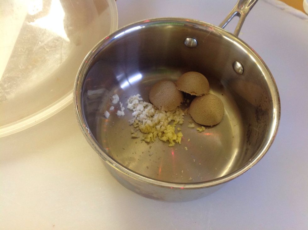 In the small sauce pot (off the heat) add the garlic, ginger, and the brown sugar.