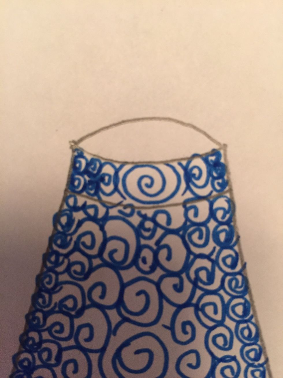 In the top of the neck, draw small shapes or symbols on the edges and bigger shapes or symbols in the center.