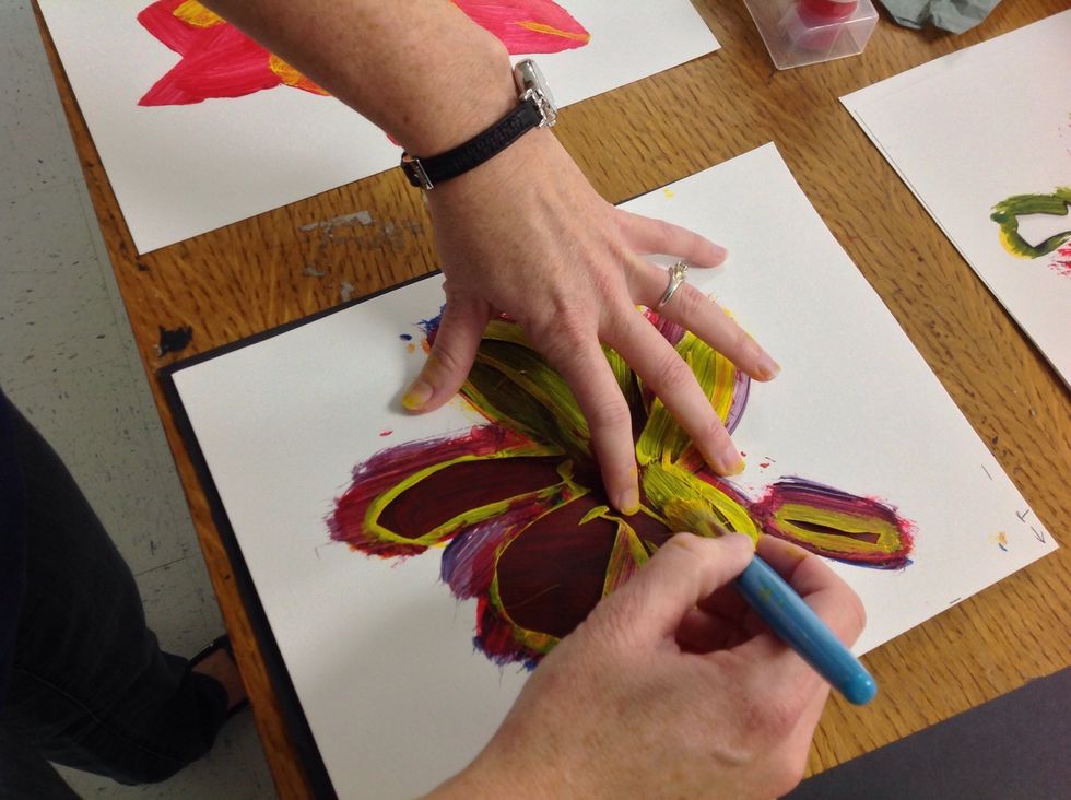 In this picture you can see the paint build up on the stencil. Immediately after printing with the stencil, I move the stencil to the scrap paper and wipe it off.