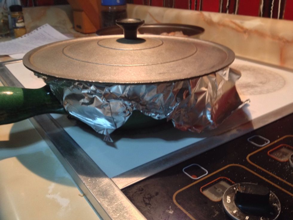 In very low heat, cover the pan with aluminum foil and lid for 15 min. Don't uncover it, don't touch it.. Your rice won't burn.. He's very happy in the pan so you don't want to bother him! :)