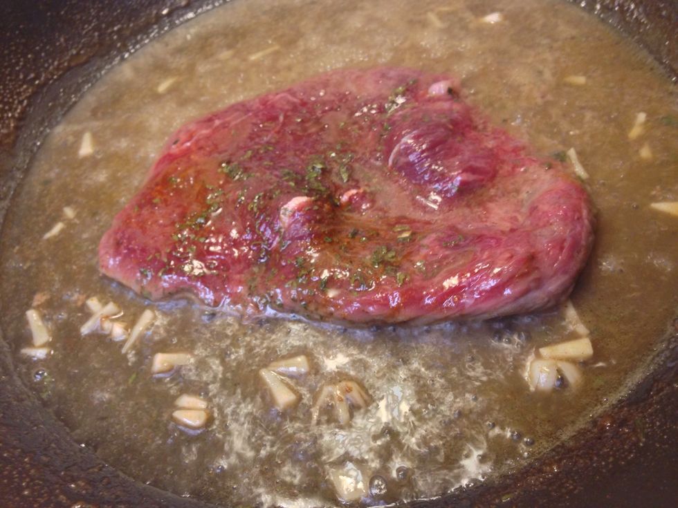 In your 10-in pan, melt down your butter and pour in 1/2 cup of water. Add your bullion and chopped garlic. Mix thoroughly. Allow your meat to cook to your likeness. Note: raw meat can be harmful
