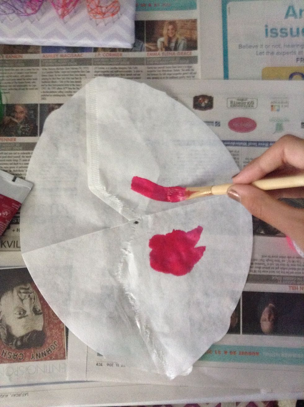 In your cup add a bit of water and squeeze some paint ( any color) into the cup. Stir the mixture until it becomes a watery paint. Then gently brush the paint onto the coffee filter and let dry.