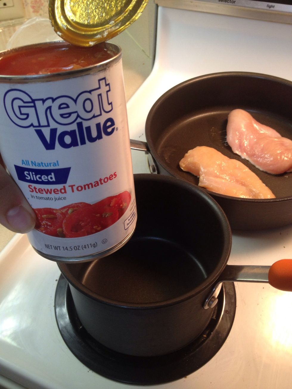 In your sauce pan start making the sauce! Dump in your can of Italian stewed tomatoes.(if you like extra saucy dishes double the batch!)