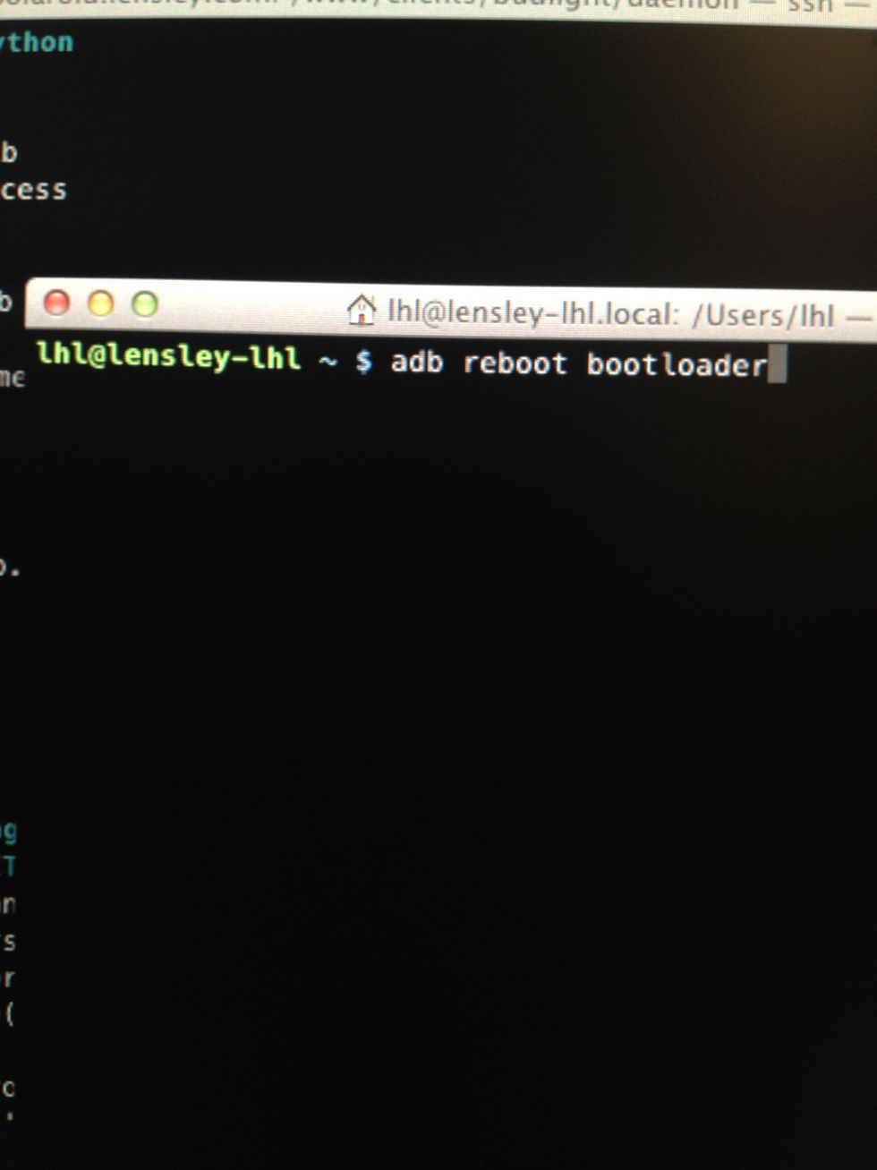 In your terminal (assuming the Android SDK platform-tools folder is in your path) type 'adb reboot bootloader' to restart your phone in the bootloader.