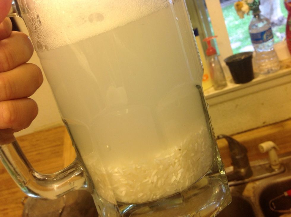 In your vessel, give your rice a quick rinse one or two times, draining the water after each rinse.