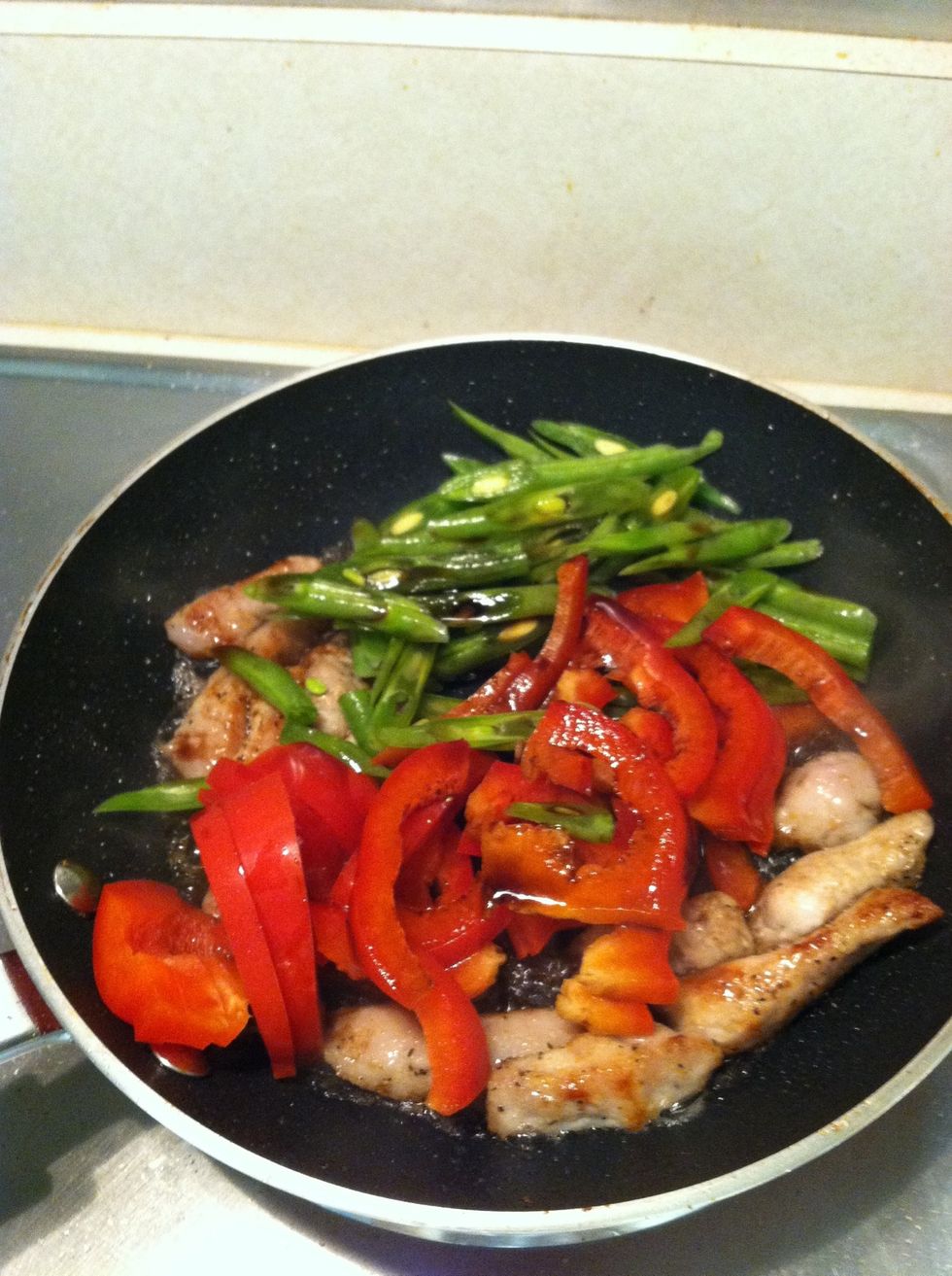 Incorporate the green beans and red pepper. Let the vegetables cook for 10-15 min on medium heat before incorporating the rest of the ingredients.