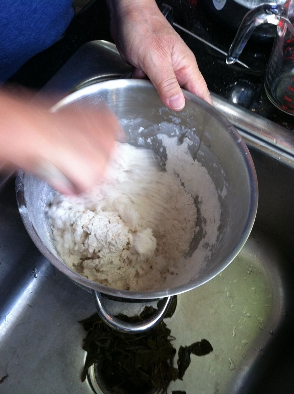 Incorporate the warm water into the dry ingredients slowly until the dough is sticky. Stir in 1 tbsp of vegetable oil.