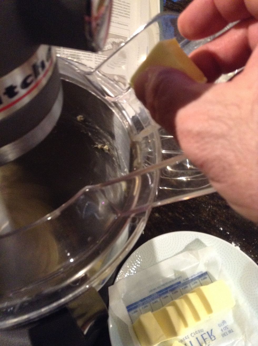 Increase speed to medium and add butter i piece at a time allowing each piece to mix in at least 20 seconds before adding an additional piece of butter. Continue to beat about 2 additional minutes.