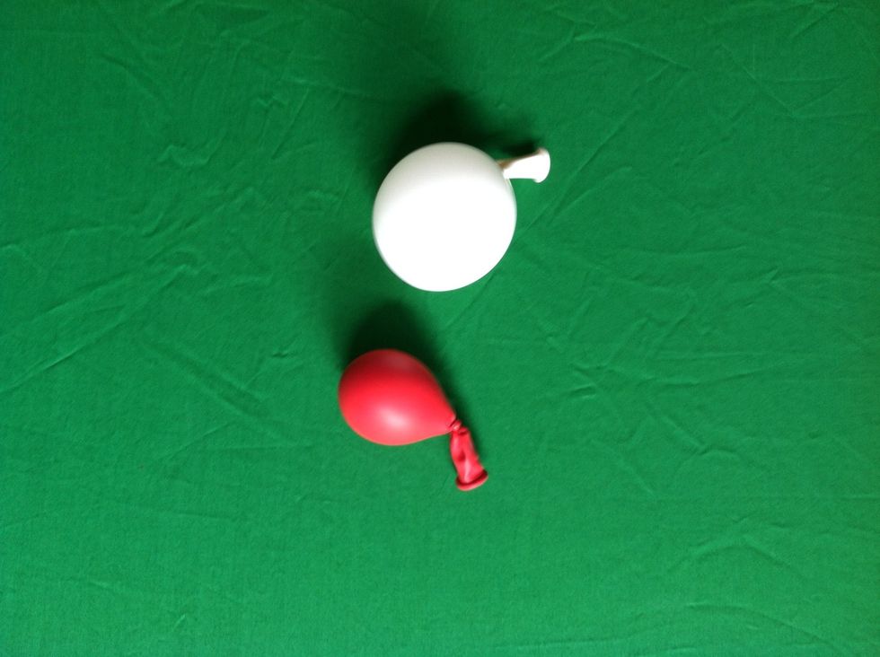 Inflate the white 5" balloon to about 1" and put just over a puff of air in the red one
