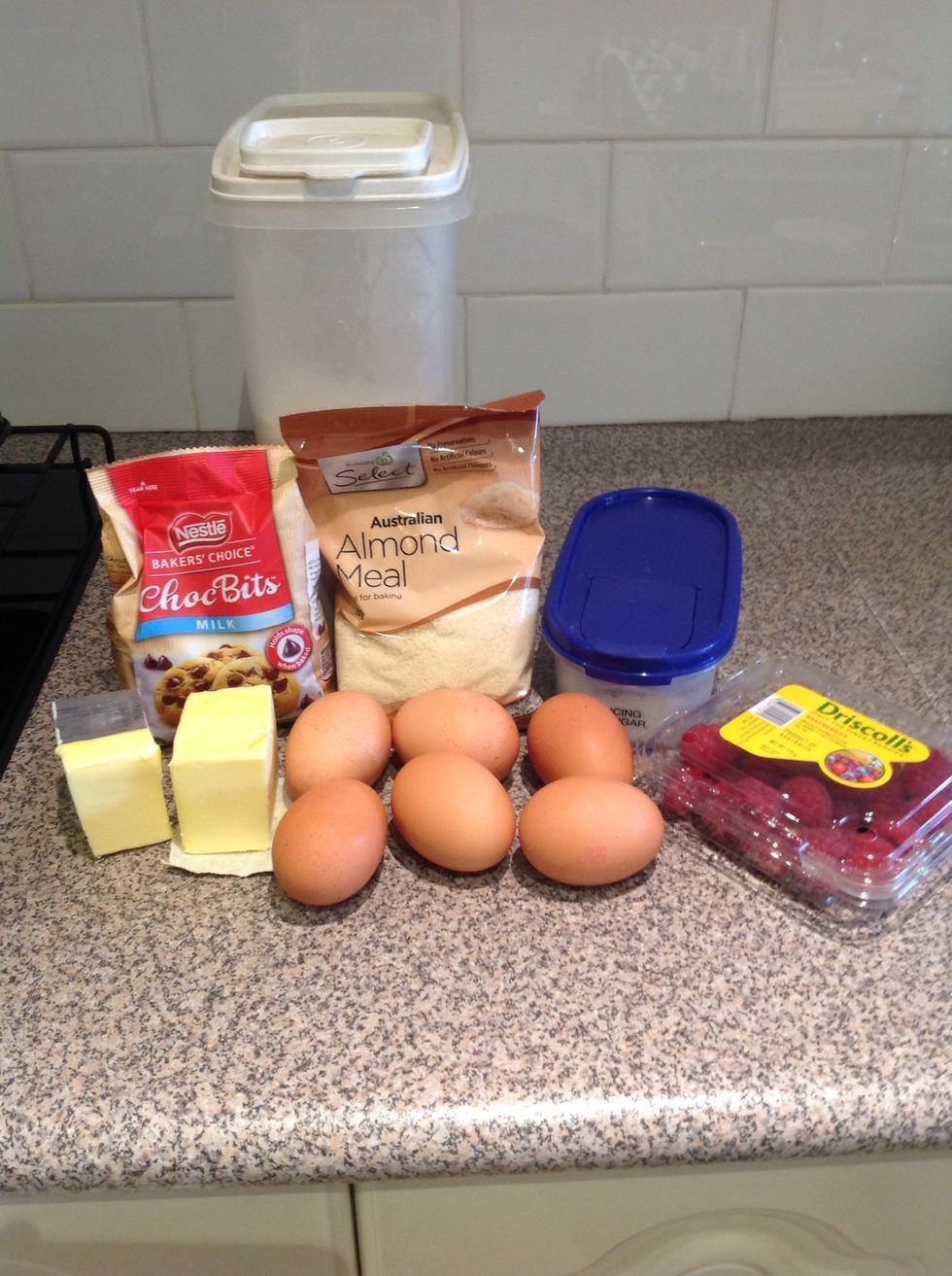 Ingredients: 180g of butter, melted, 1 cup almond or hazelnut meal, 6 egg whites, beaten lightly, 1 1/2 cups icing sugar mixture  sifted, 1/2 cup plain flour, raspberries and choc chips.