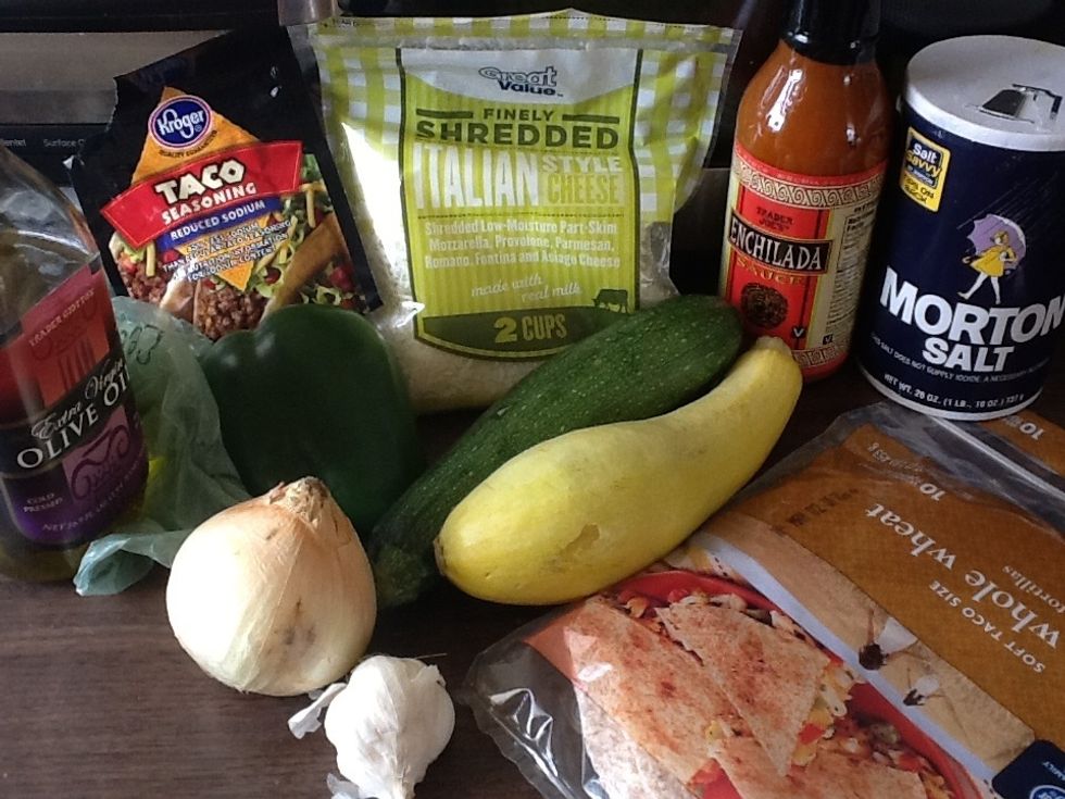 Ingredients: black beans, olive oil, zucchini, squash, onion, garlic, bell pepper, soft tortilla, salt, taco seasoning, enchilada sauce, shredded Mexican cheese