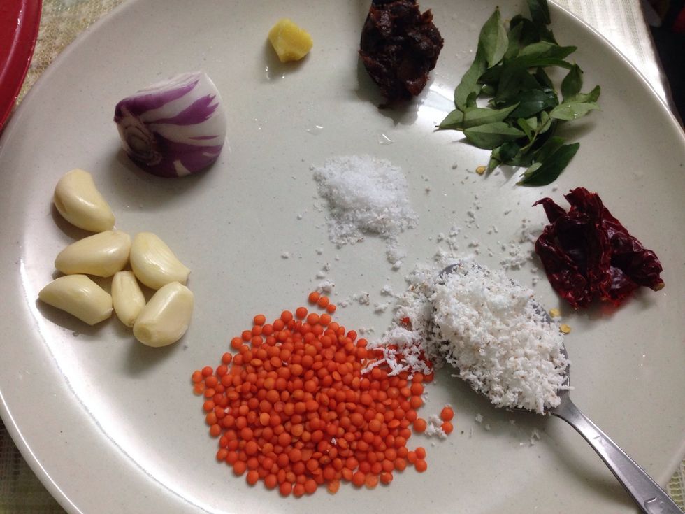 Ingredients....garlic, onion, ginger, tamarind, curry leaves, dried chillies, coconut, Mysore dhal (u can substitute with urad dhal) and salt. This is my mum's recipe:)