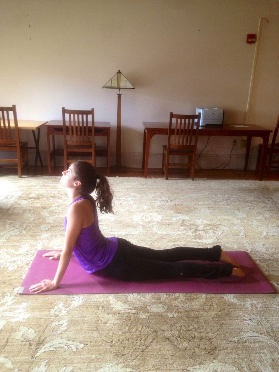 Inhale into Up Dog. Lengthened legs and arms press into floor and upper body lifts up. Drishti (gaze) is upward with a stretch through the neck.