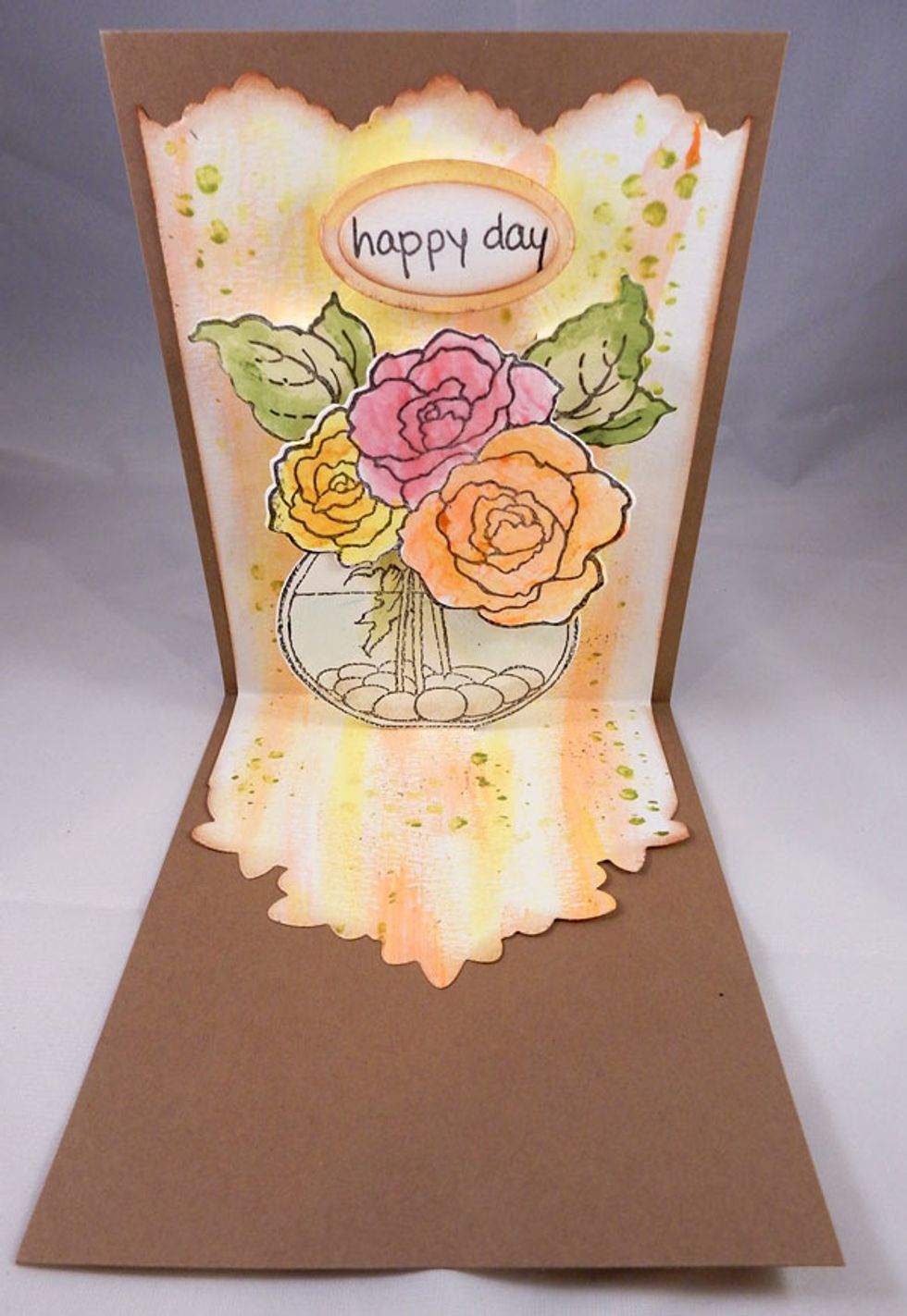 Ink around panel with brown ink.  Assemble the painted pieces and adhere to the tabs created during the die cutting process.