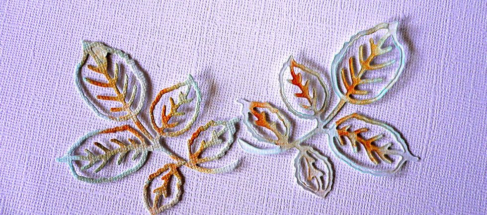 Ink around the top of these die cut leaves with Lagoon/Green ink pad and Rustic Hinge ink pad. Adhere these to the front of card on top of the Rosey Frame die cut.