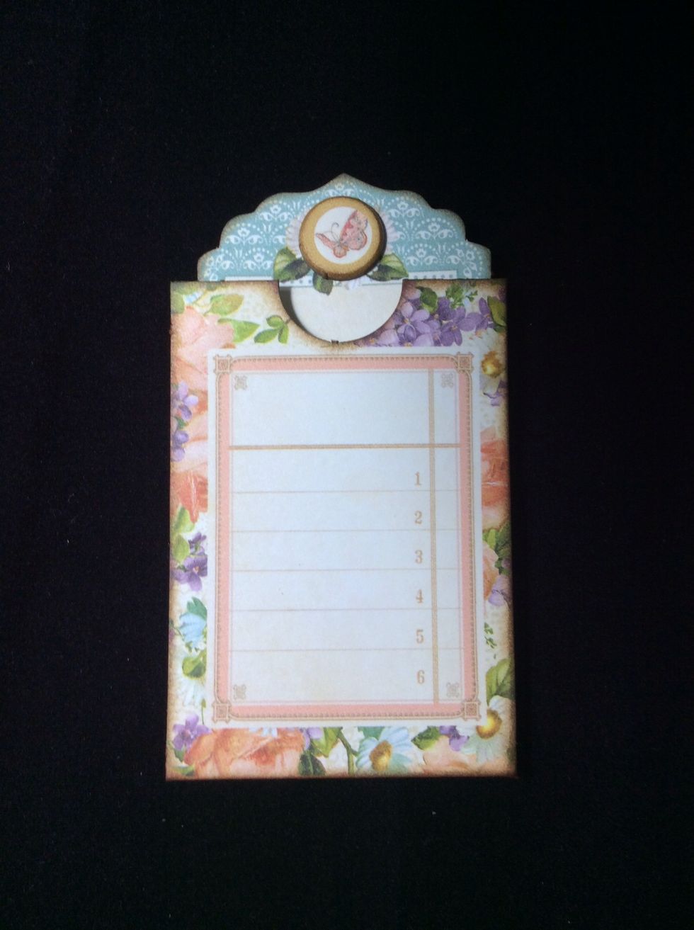 Ink edges of both components. Pocket and tag should look as in photo. Adhere small embellishment to top of tag if desired.