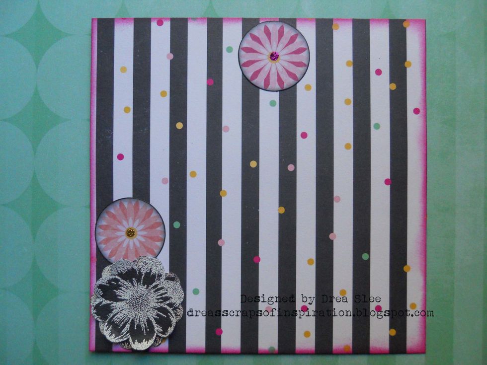 Ink edges of three of the circle shaped flowers that come in the Noteworthy pack with Black Soot Distress Ink. Add a dot of Stickles to the centers, and put one aside.