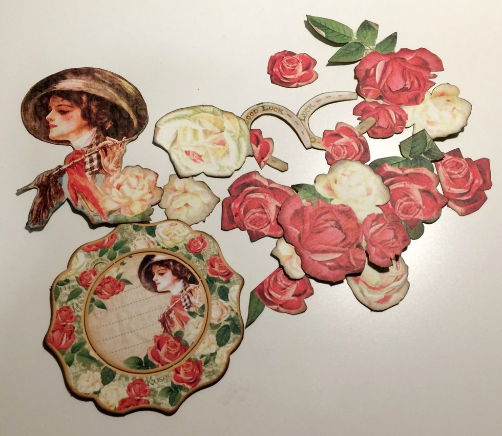 Ink the edges of the roses, the roses attached to the horseshoes, image of the lady and chipboard piece using a blending tool and Walnut Stain Distress Ink.