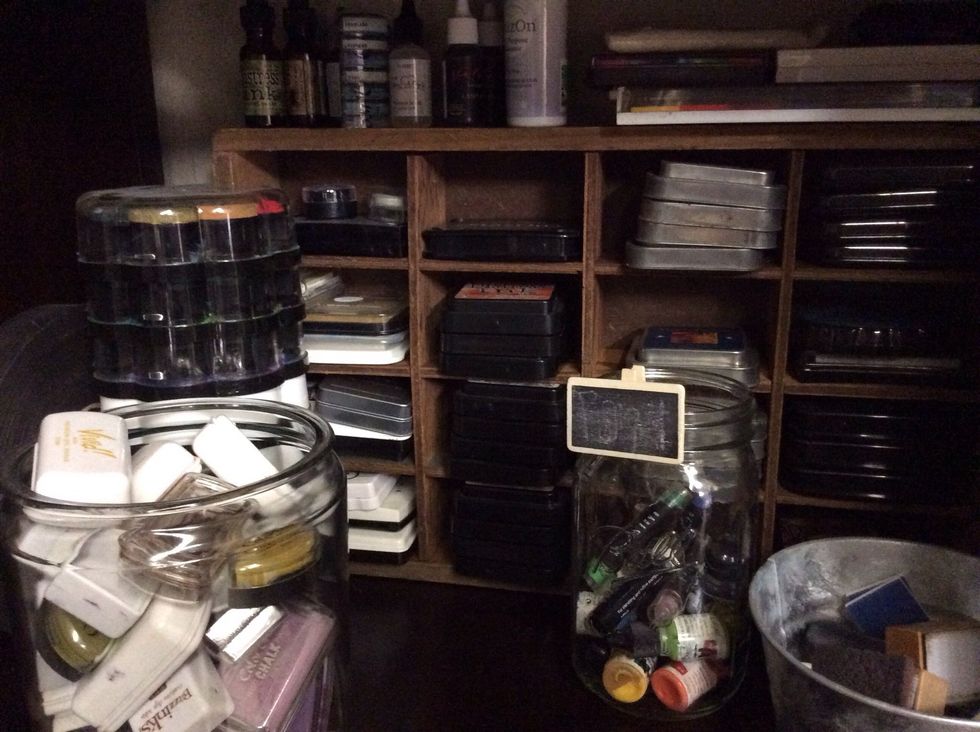 Inks stacked neatly and stored in large jars.