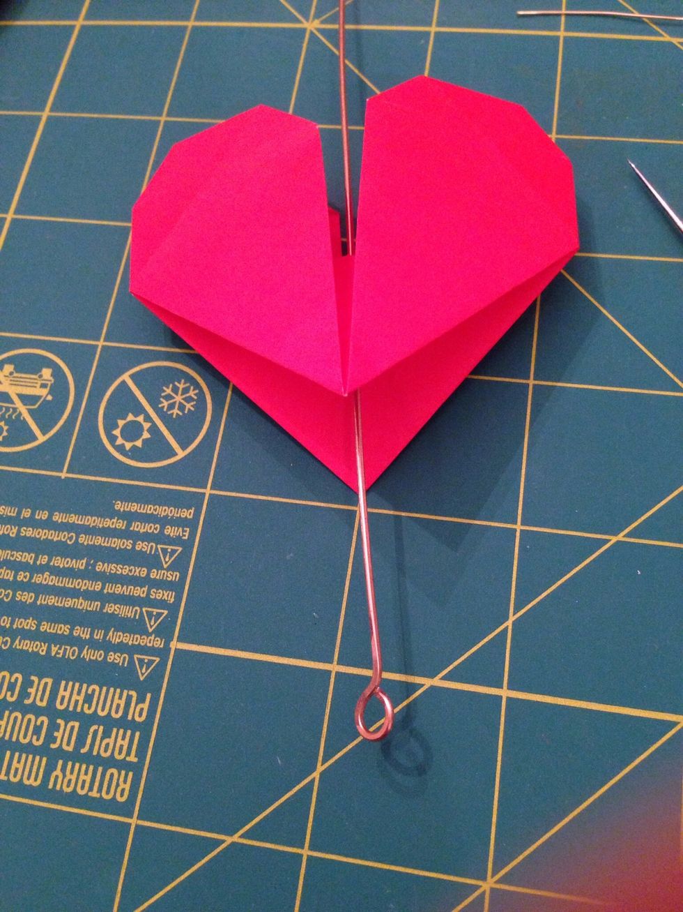 Insert a head or eye pine made of wire (I made my own out of wire from a hardware store) through the hole.