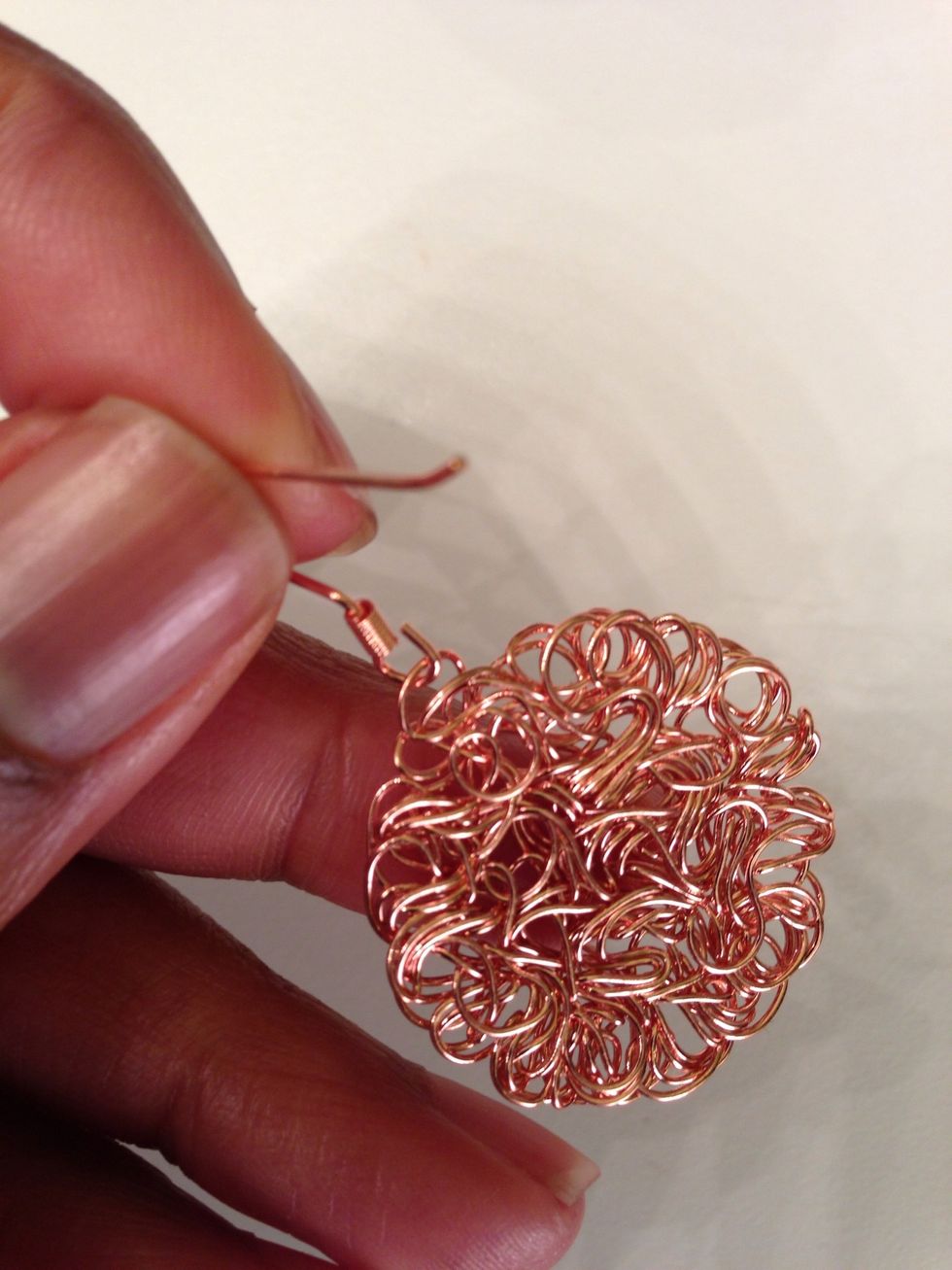 Insert a loop of the metal blank onto the open loop of the ear wire.