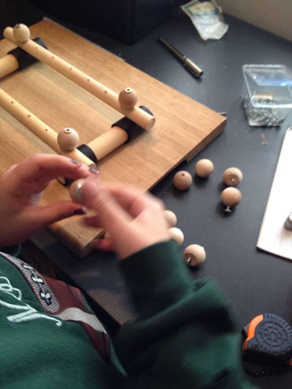 Insert a shorter screw into each of the remaining 10 knobs ( 1 knob is for the mallet, do not put a screw into that knob)