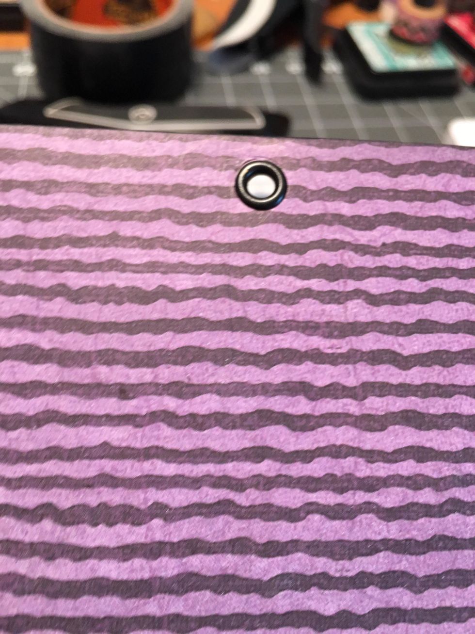 Insert an eyelet and set it on the back cover .