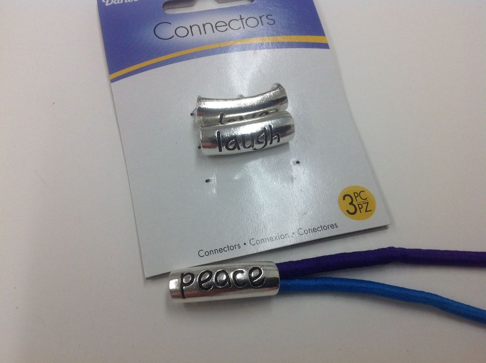 Insert both cords through a curved word tube. You will probably need to use the t-pin to help feed the cord through the tube.