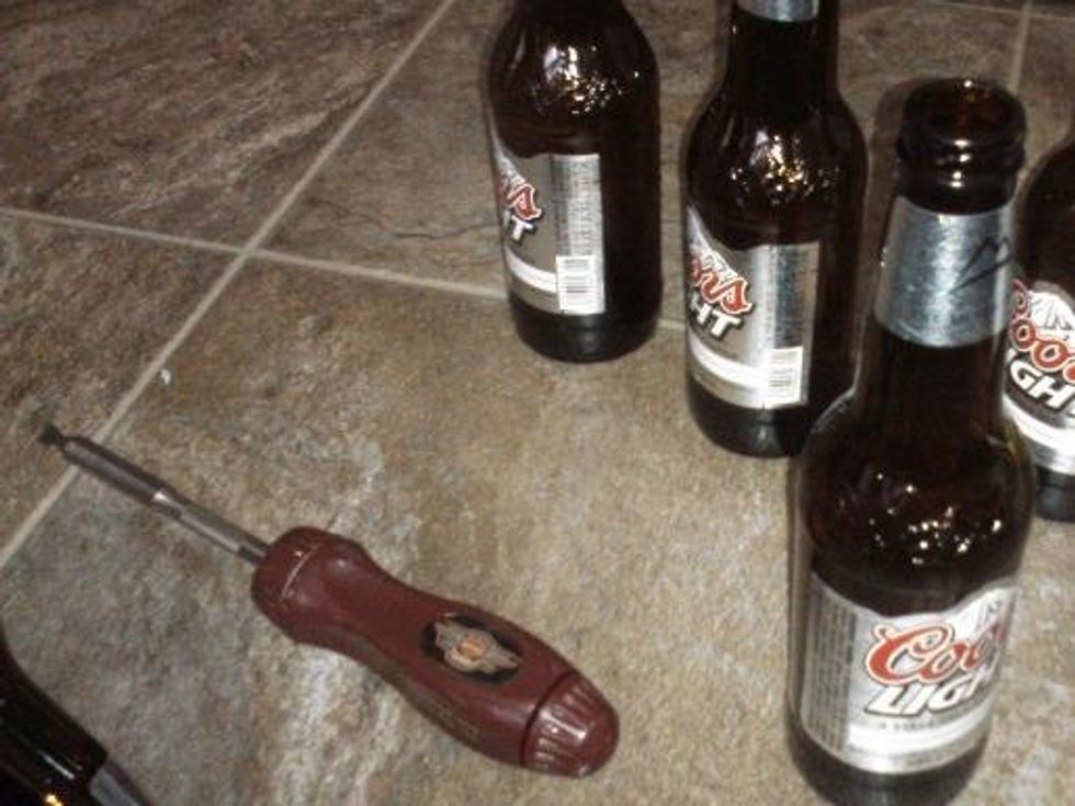 Insert bottles into hose clamps and tighten. Being mindful of hanging direction if that's important to you.