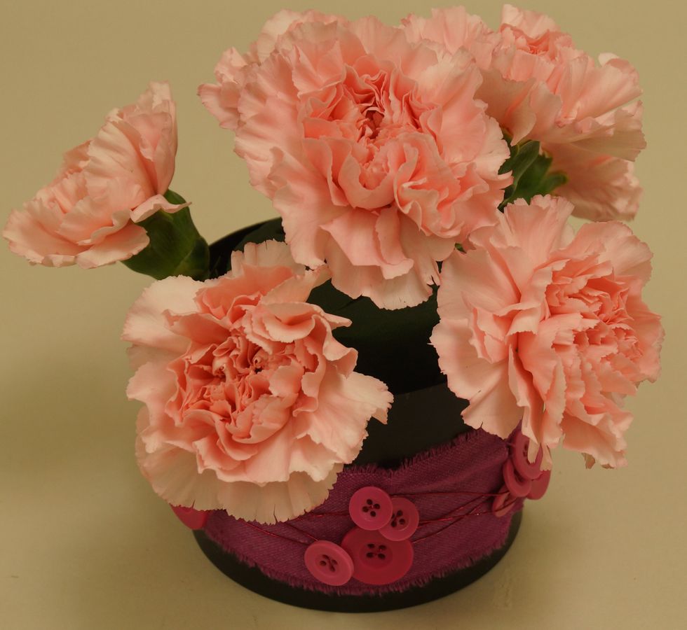 Insert carnations into foam.