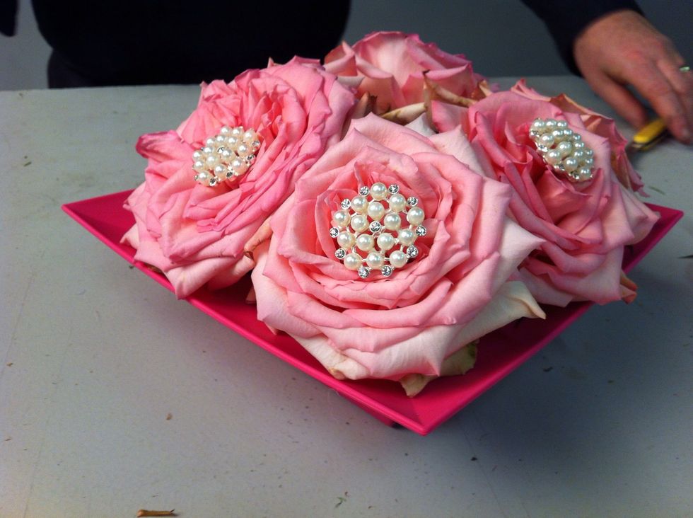 Insert clipped brooches into center of each rose.