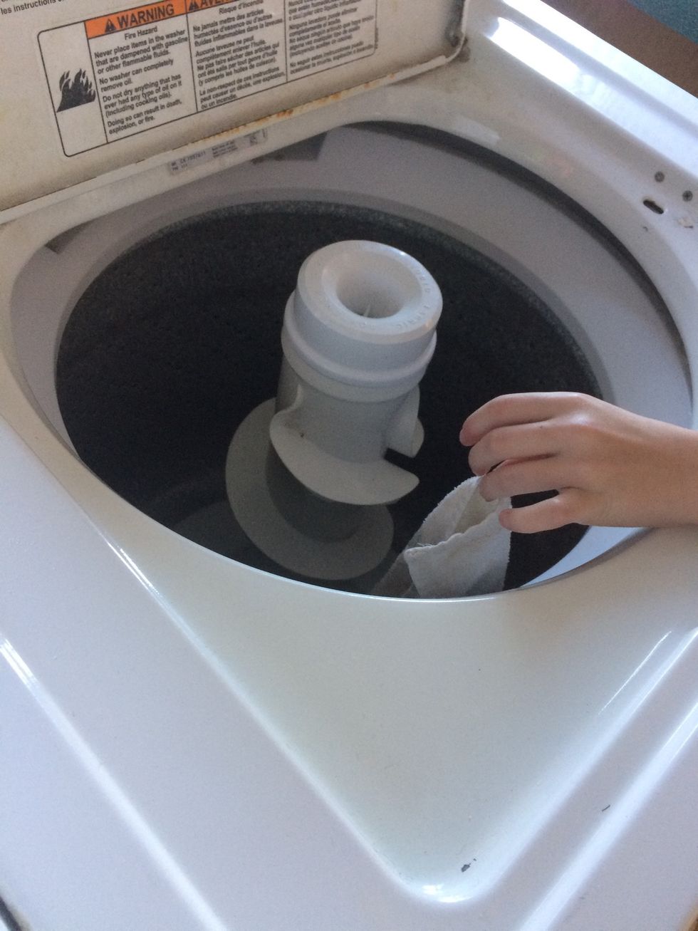 Insert dirty towels into washer