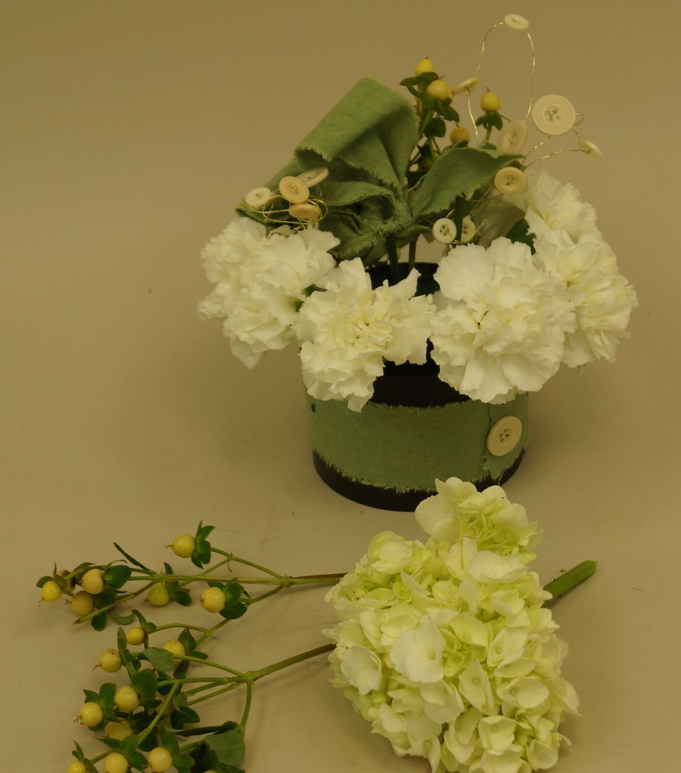 Insert flowers, berries, OASIS\u2122 Raw Muslin and OASIS\u2122 Button Wire into OASIS\u00ae Floral Foam Maxlife.